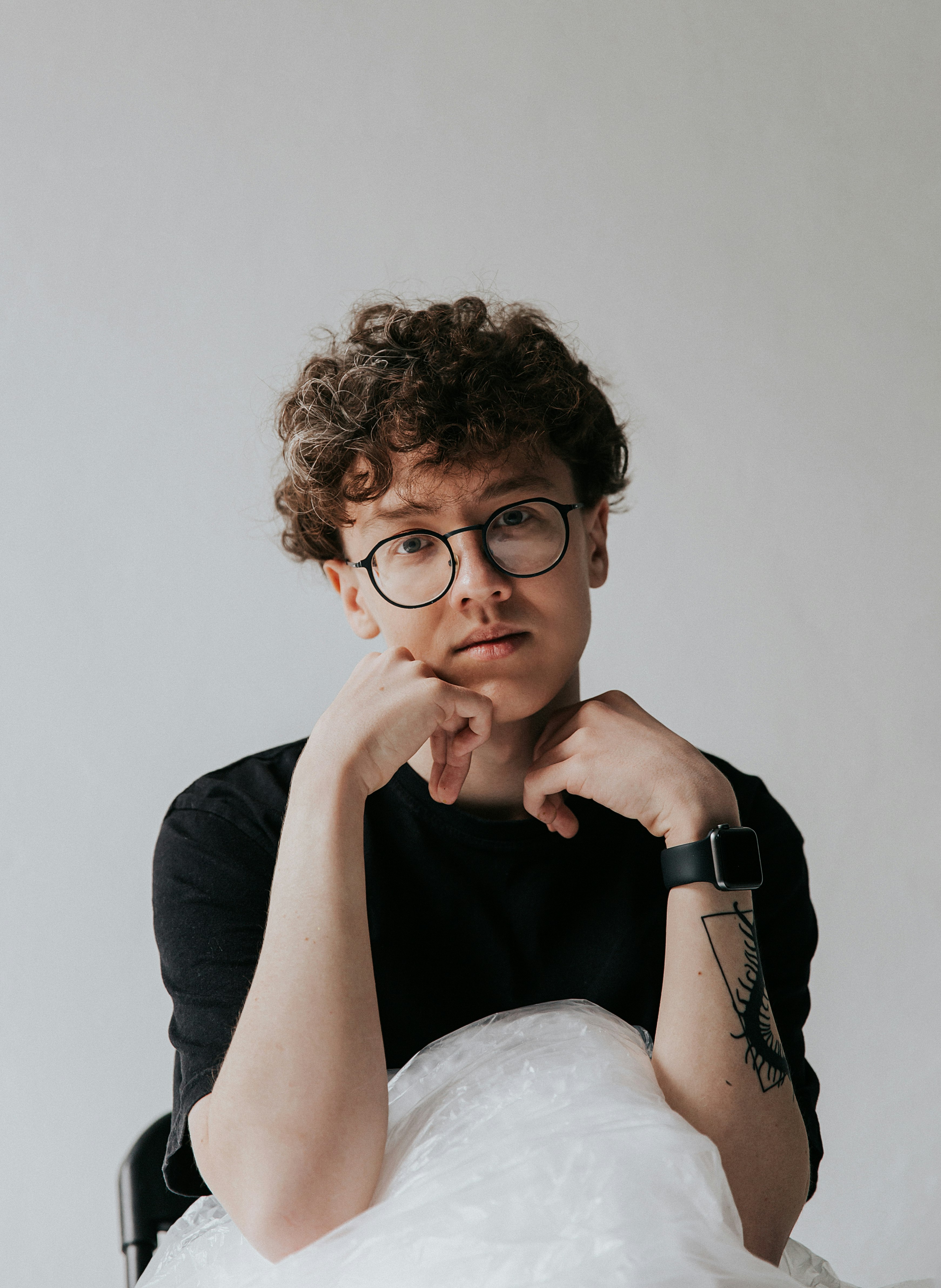 man in black long sleeve shirt wearing black framed eyeglasses